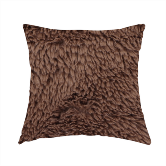 The fabric used to create this handmade cushion is a deep, rich chocolate brown, high-pile faux fur fabric. It has a dense, luxurious texture with soft, tousled fibres that give it a warm and cosy shag-like appearance.