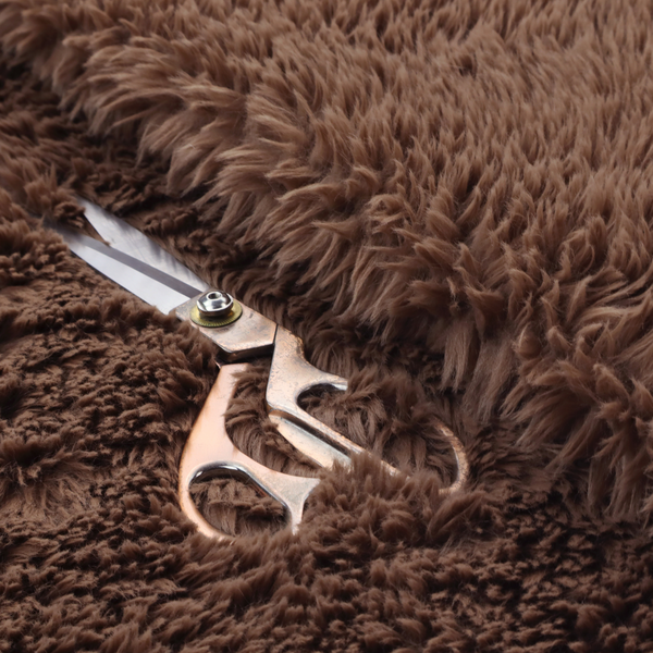 A deep, rich chocolate brown, high-pile faux fur fabric. It has a dense, luxurious texture with soft, tousled fibres that give it a warm and cosy shag-like appearance.