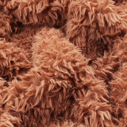 A rust or burnt-orange, high-pile faux fur fabric. It features a unique, wavy or rippled texture created by the directional alignment of the plush, soft fibres, giving it a distinctive shag-like appearance.