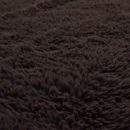A deep, dark espresso or near-black, high-pile faux fur fabric. It displays a dense, luxurious texture with soft, slightly tousled fibres that create a cosy, sophisticated shag-like appearance.
