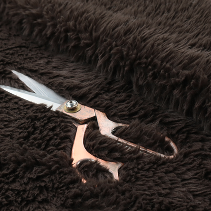 A deep, dark espresso or near-black, high-pile faux fur fabric. It displays a dense, luxurious texture with soft, slightly tousled fibres that create a cosy, sophisticated shag-like appearance.