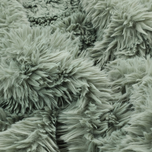A muted, sage green, high-pile faux fur fabric. It features a dense, luxurious texture with soft, tousled fibres that create a cosy, shag-like appearance.