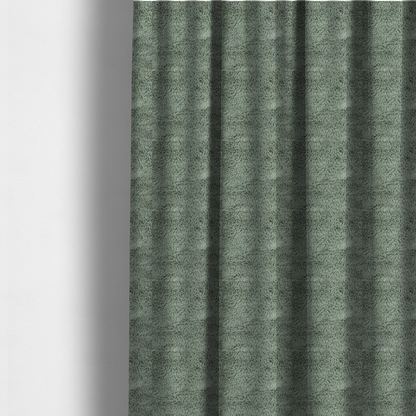 The fabric used to create these made-to-measure curtains is a muted, sage green, high-pile faux fur fabric. It features a dense, luxurious texture with soft, tousled fibres that create a cosy, shag-like appearance.