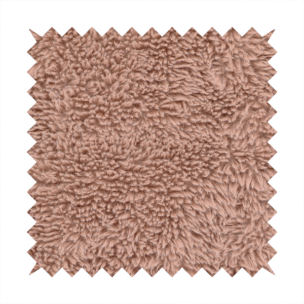 A dusty rose or soft mauve, high-pile faux fur fabric. It features a dense, luxurious texture with soft, tousled fibres that create a cosy, shag-like appearance.