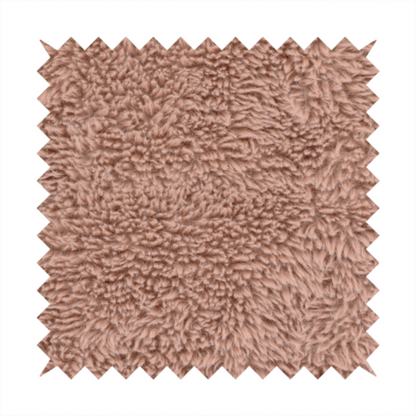 A dusty rose or soft mauve, high-pile faux fur fabric. It features a dense, luxurious texture with soft, tousled fibres that create a cosy, shag-like appearance.