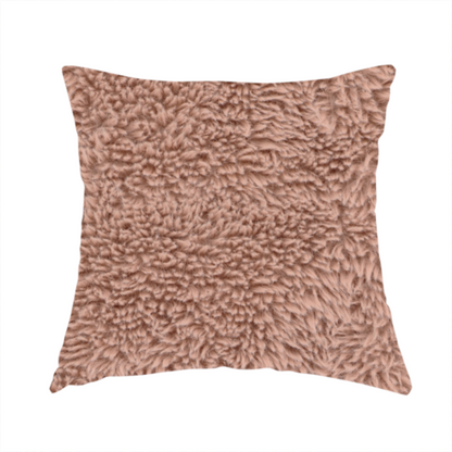 The fabric used to create this handmade cushion is a dusty rose or soft mauve, high-pile faux fur fabric. It features a dense, luxurious texture with soft, tousled fibres that create a cosy, shag-like appearance.