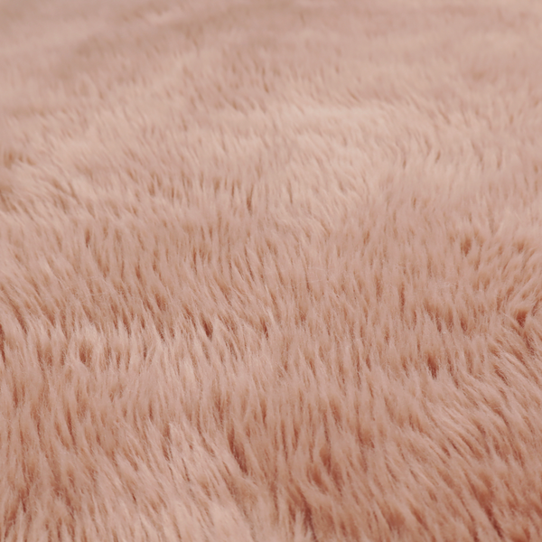 A dusty rose or soft mauve, high-pile faux fur fabric. It features a dense, luxurious texture with soft, tousled fibres that create a cosy, shag-like appearance.