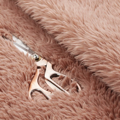 A dusty rose or soft mauve, high-pile faux fur fabric. It features a dense, luxurious texture with soft, tousled fibres that create a cosy, shag-like appearance.