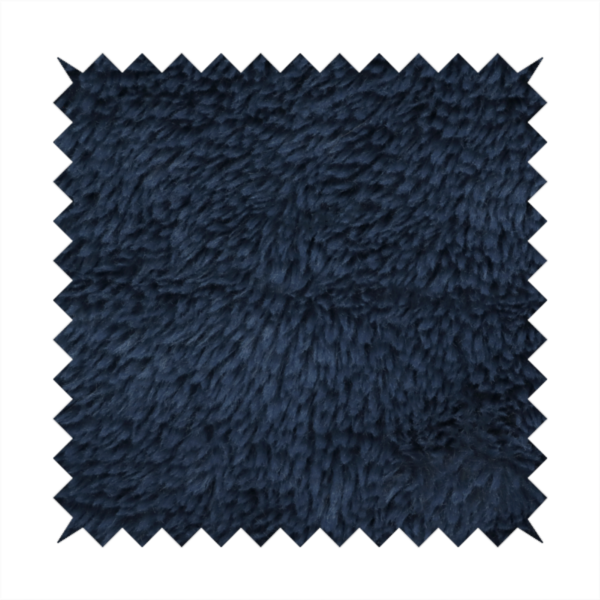 A deep navy blue, high-pile faux fur fabric. It displays a dense, luxurious texture with soft, slightly tousled fibres that create a cosy and sophisticated shag-like appearance.