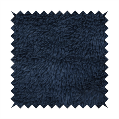 A deep navy blue, high-pile faux fur fabric. It displays a dense, luxurious texture with soft, slightly tousled fibres that create a cosy and sophisticated shag-like appearance.