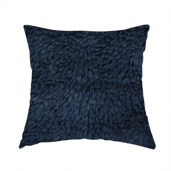 The fabric used to create this handmade cushion is a deep navy blue, high-pile faux fur fabric. It displays a dense, luxurious texture with soft, slightly tousled fibres that create a cosy and sophisticated shag-like appearance.