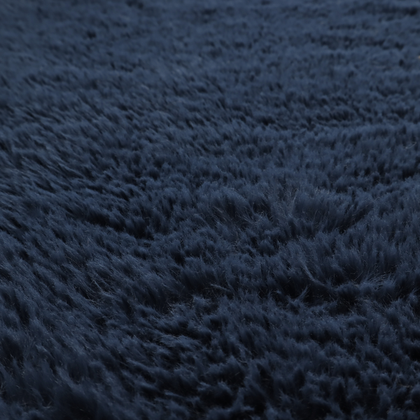 A deep navy blue, high-pile faux fur fabric. It displays a dense, luxurious texture with soft, slightly tousled fibres that create a cosy and sophisticated shag-like appearance.