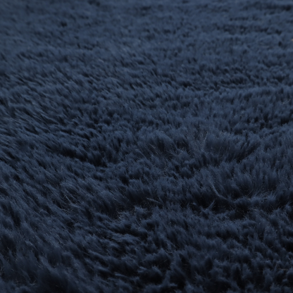 A deep navy blue, high-pile faux fur fabric. It displays a dense, luxurious texture with soft, slightly tousled fibres that create a cosy and sophisticated shag-like appearance.
