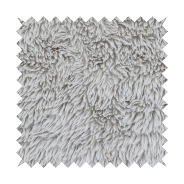 A cool-toned, light silver-grey high-pile faux fur fabric. It has a dense, plush texture characterized by soft, tousled fibres that create a cosy, shag-like appearance.