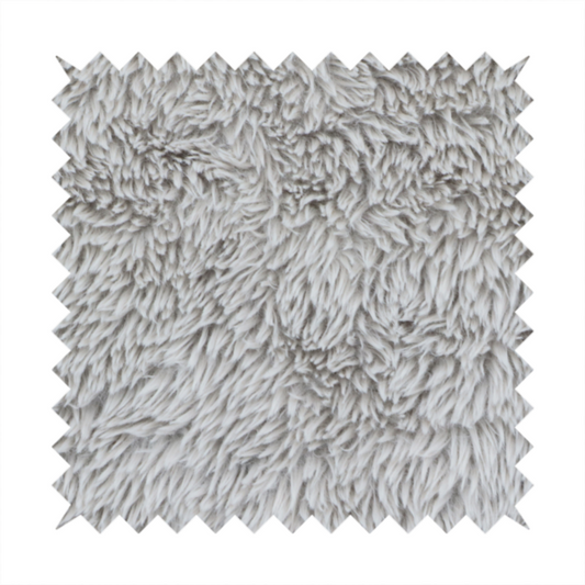 A cool-toned, light silver-grey high-pile faux fur fabric. It has a dense, plush texture characterized by soft, tousled fibres that create a cosy, shag-like appearance.