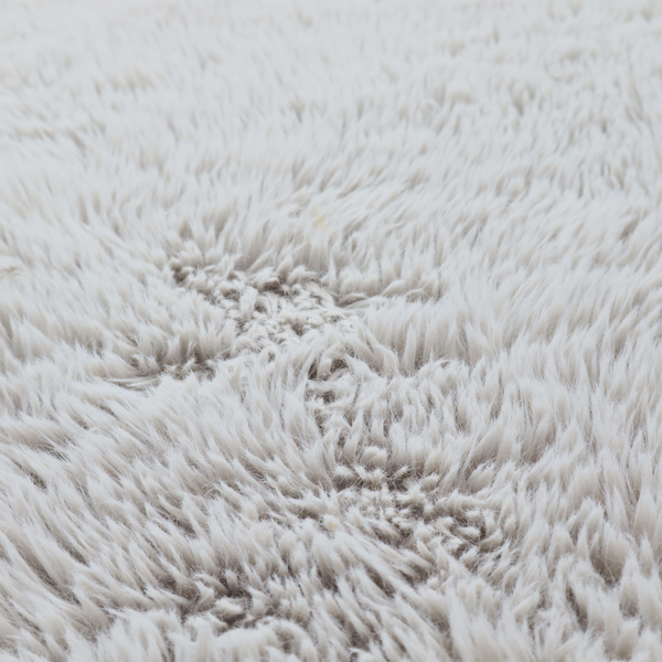 A cool-toned, light silver-grey high-pile faux fur fabric. It has a dense, plush texture characterized by soft, tousled fibres that create a cosy, shag-like appearance.