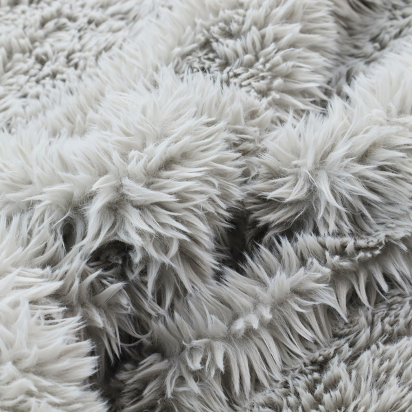 A cool-toned, light silver-grey high-pile faux fur fabric. It has a dense, plush texture characterized by soft, tousled fibres that create a cosy, shag-like appearance.