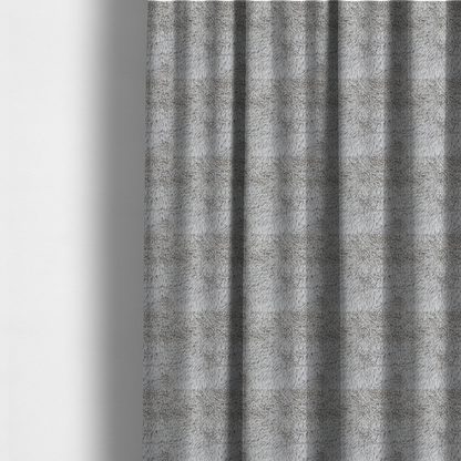 The fabric used to create these made-to-measure curtains is a cool-toned, light silver-grey high-pile faux fur fabric. It has a dense, plush texture characterized by soft, tousled fibres that create a cosy, shag-like appearance.