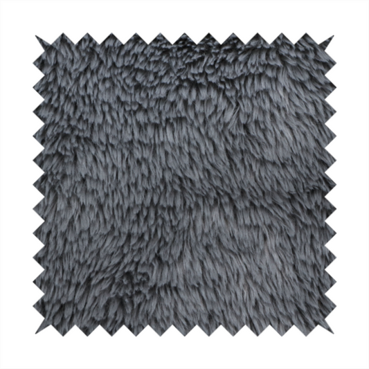 A dark charcoal-grey, high-pile faux fur fabric. It displays a dense, luxurious texture with soft, slightly tousled fibres that create a cosy and sophisticated shag-like appearance.