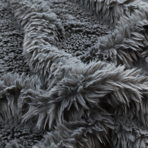 A dark charcoal-grey, high-pile faux fur fabric. It displays a dense, luxurious texture with soft, slightly tousled fibres that create a cosy and sophisticated shag-like appearance.