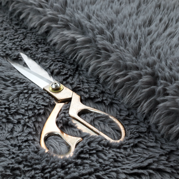 A dark charcoal-grey, high-pile faux fur fabric. It displays a dense, luxurious texture with soft, slightly tousled fibres that create a cosy and sophisticated shag-like appearance.