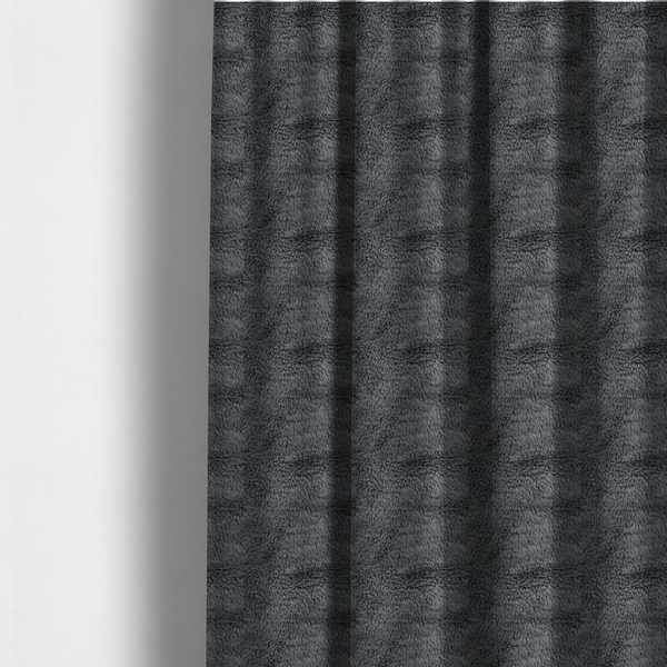 The fabric used to create these made-to-measure curtains is a dark charcoal-grey, high-pile faux fur fabric. It displays a dense, luxurious texture with soft, slightly tousled fibres that create a cosy and sophisticated shag-like appearance.