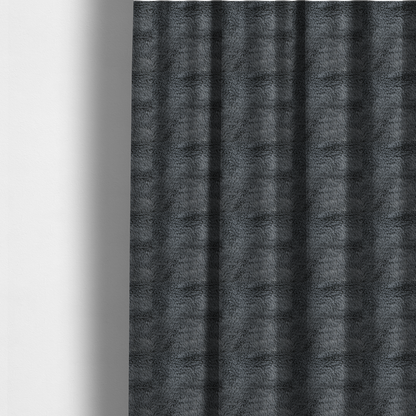 The fabric used to create these made-to-measure curtains is a dark charcoal-grey, high-pile faux fur fabric. It displays a dense, luxurious texture with soft, slightly tousled fibres that create a cosy and sophisticated shag-like appearance.