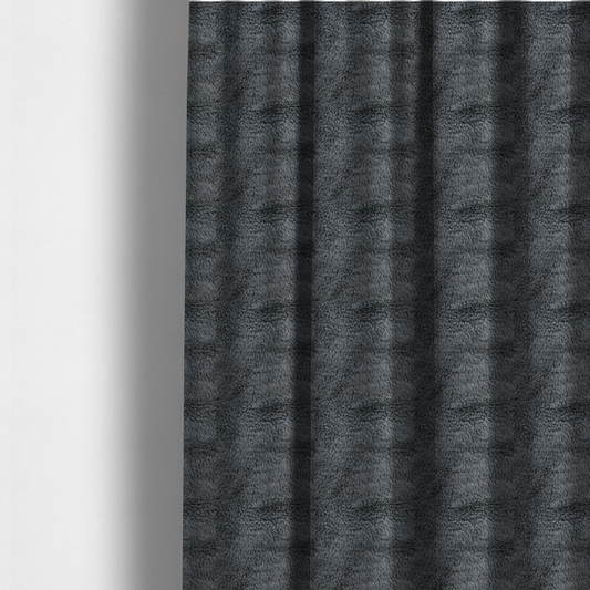 The fabric used to create these made-to-measure curtains is a dark charcoal-grey, high-pile faux fur fabric. It displays a dense, luxurious texture with soft, slightly tousled fibres that create a cosy and sophisticated shag-like appearance.