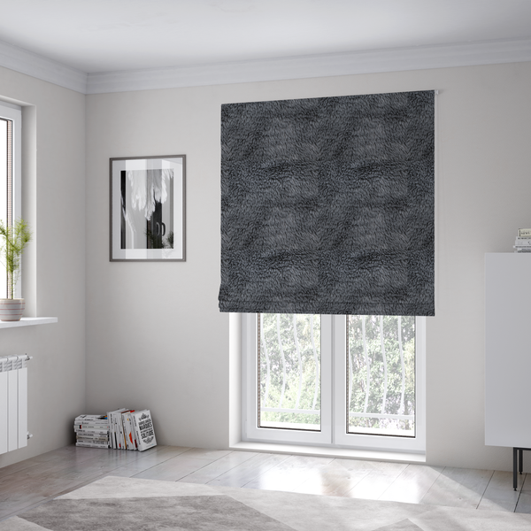 The fabric used to create these Roman blinds is a dark charcoal-grey, high-pile faux fur fabric. It displays a dense, luxurious texture with soft, slightly tousled fibres that create a cosy and sophisticated shag-like appearance.