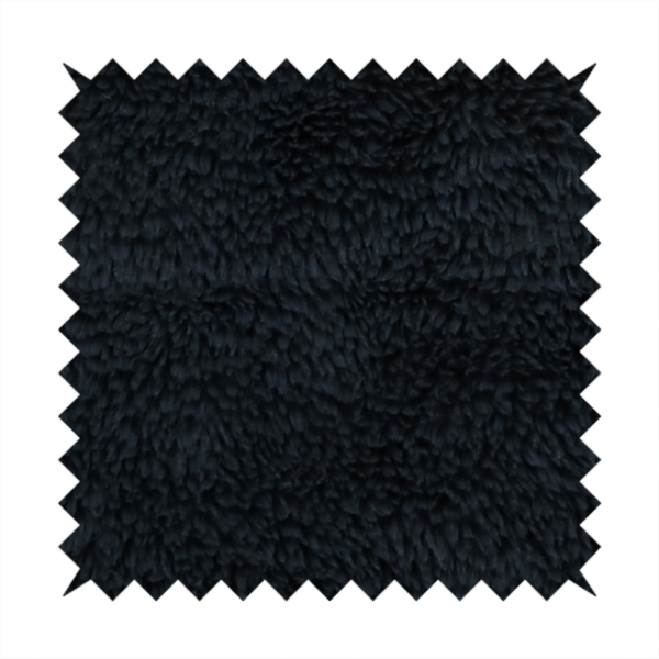 a solid black, high-pile faux fur fabric. It displays a dense, luxurious texture with soft, tousled fibres that create a cosy, sophisticated, and uniform shag-like appearance.