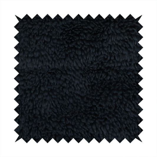 a solid black, high-pile faux fur fabric. It displays a dense, luxurious texture with soft, tousled fibres that create a cosy, sophisticated, and uniform shag-like appearance.