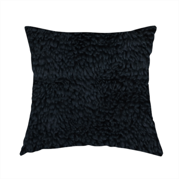 The fabric used to create this handmade cushion is a solid black, high-pile faux fur fabric. It displays a dense, luxurious texture with soft, tousled fibres that create a cosy, sophisticated, and uniform shag-like appearance.