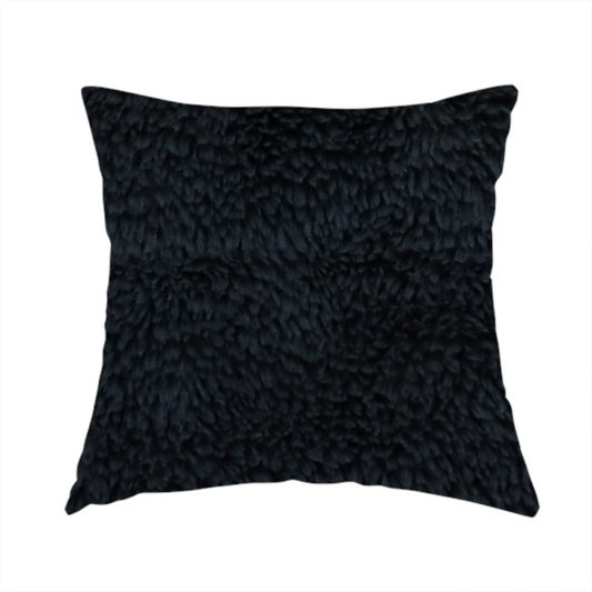 The fabric used to create this handmade cushion is a solid black, high-pile faux fur fabric. It displays a dense, luxurious texture with soft, tousled fibres that create a cosy, sophisticated, and uniform shag-like appearance.