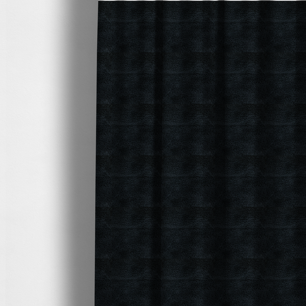 The fabric used to create these made-to-measure curtains is a solid black, high-pile faux fur fabric. It displays a dense, luxurious texture with soft, tousled fibres that create a cosy, sophisticated, and uniform shag-like appearance.