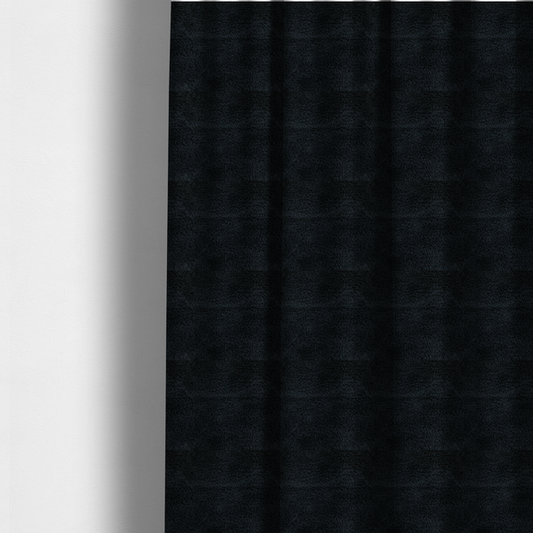 The fabric used to create these made-to-measure curtains is a solid black, high-pile faux fur fabric. It displays a dense, luxurious texture with soft, tousled fibres that create a cosy, sophisticated, and uniform shag-like appearance.