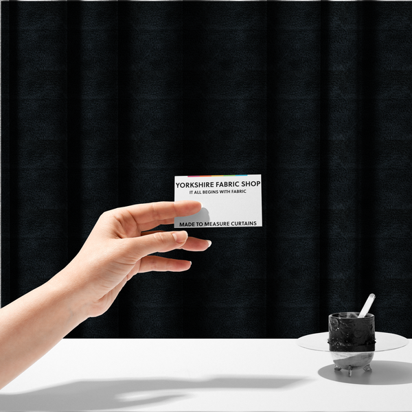 The fabric used to create these made-to-measure curtains is a solid black, high-pile faux fur fabric. It displays a dense, luxurious texture with soft, tousled fibres that create a cosy, sophisticated, and uniform shag-like appearance.