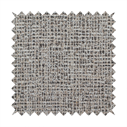 A textured, woven fabric featuring a complex pattern of beige, black, and white threads, creating a speckled and mottled appearance.