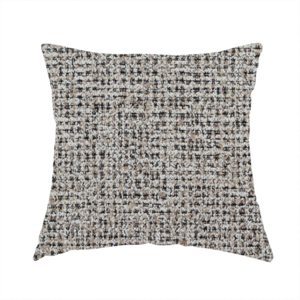 The fabric used to create this handmade cushion is a textured, woven fabric featuring a complex pattern of beige, black, and white threads, creating a speckled and mottled appearance.