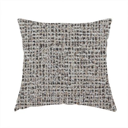 The fabric used to create this handmade cushion is a textured, woven fabric featuring a complex pattern of beige, black, and white threads, creating a speckled and mottled appearance.