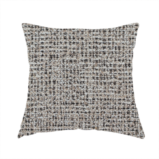 The fabric used to create this handmade cushion is a textured, woven fabric featuring a complex pattern of beige, black, and white threads, creating a speckled and mottled appearance.