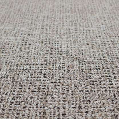 A textured, woven fabric featuring a complex pattern of beige, black, and white threads, creating a speckled and mottled appearance.