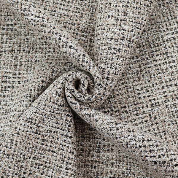 A textured, woven fabric featuring a complex pattern of beige, black, and white threads, creating a speckled and mottled appearance.
