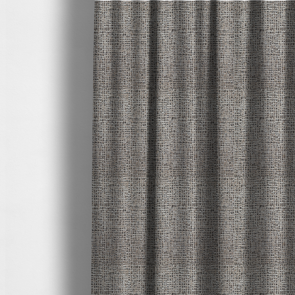 The fabric used to create these made-to-measure curtains is a textured, woven fabric featuring a complex pattern of beige, black, and white threads, creating a speckled and mottled appearance.