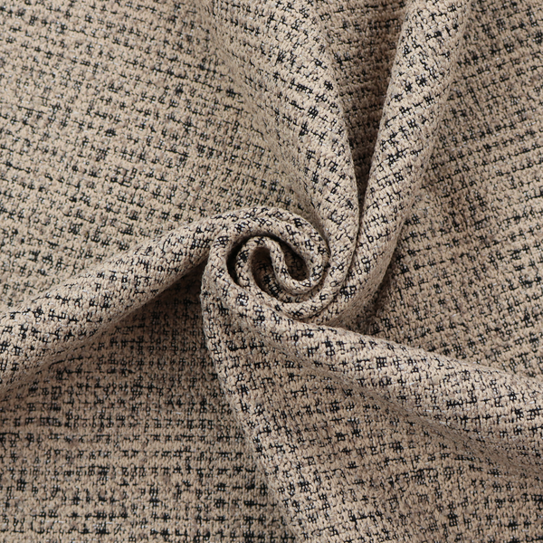 A textured, woven fabric featuring a complex pattern of beige, black, and white threads, creating a speckled and mottled appearance.