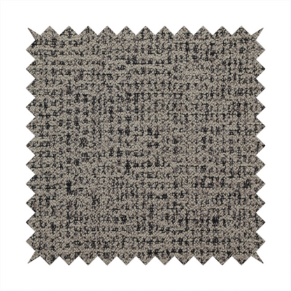 A textured, woven fabric featuring a complex pattern of beige, black, and white threads, creating a speckled and mottled appearance.