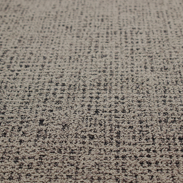 A textured, woven fabric featuring a complex pattern of beige, black, and white threads, creating a speckled and mottled appearance.