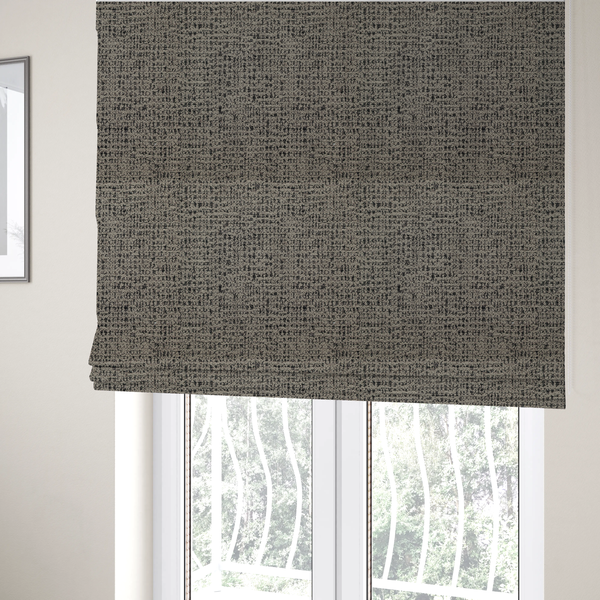 The fabric used to create these Roman blinds is a textured, woven fabric featuring a complex pattern of beige, black, and white threads, creating a speckled and mottled appearance.