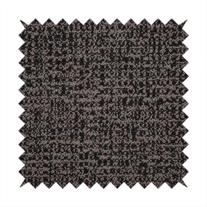A textured, woven fabric featuring a complex pattern of dark brown, black, and beige threads, creating a speckled and mottled appearance.