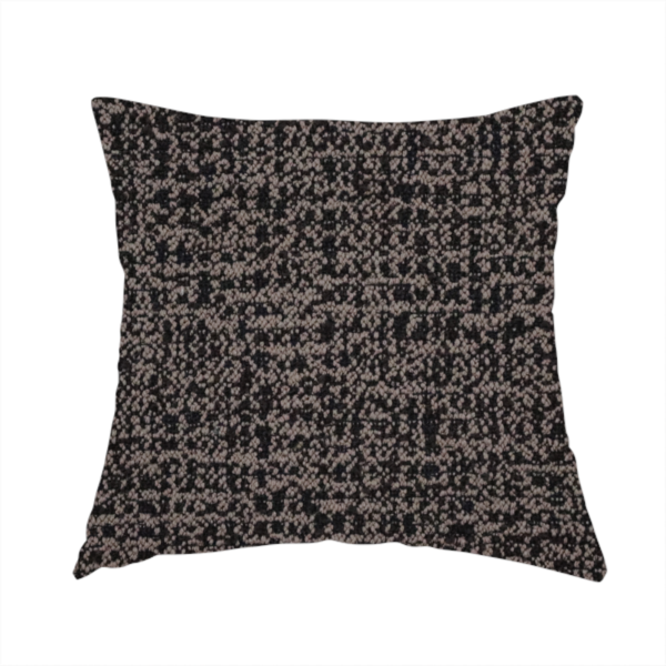 The fabric used to create this handmade cushion is a textured, woven fabric featuring a complex pattern of dark brown, black, and beige threads, creating a speckled and mottled appearance.