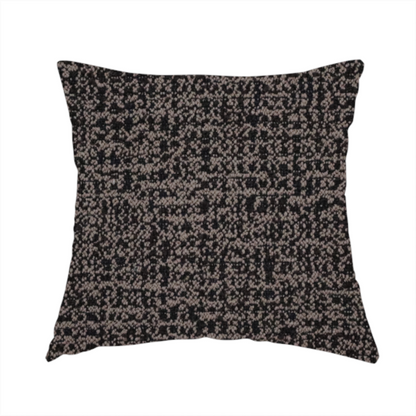 The fabric used to create this handmade cushion is a textured, woven fabric featuring a complex pattern of dark brown, black, and beige threads, creating a speckled and mottled appearance.